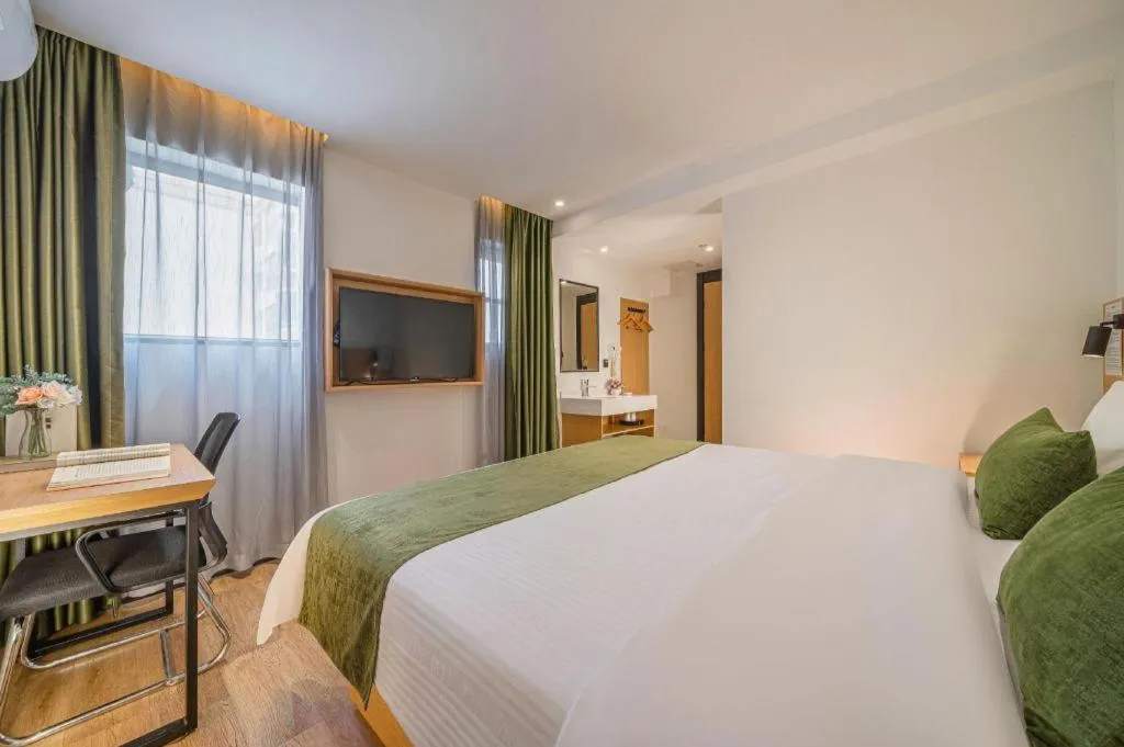 Bed in Green Tree Inn Guangxi Wuzhou 2nd Xinxing Road Liangguang Market