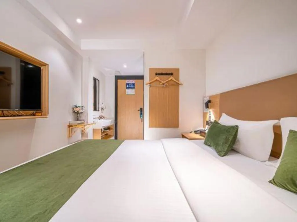 Bed in Green Tree Inn Guangxi Wuzhou 2nd Xinxing Road Liangguang Market