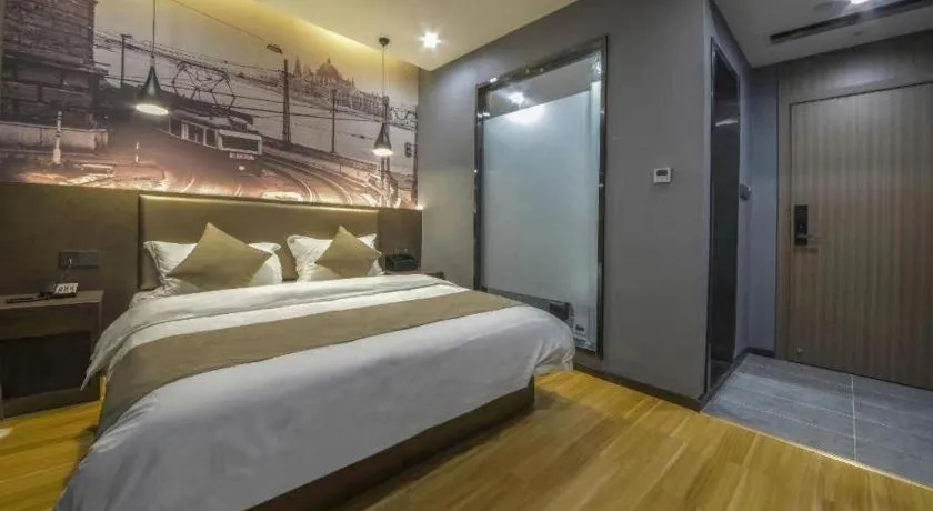 Bed in Shell Hotel Zhengzhou East High-Speed Railway Station Zhengdong Commerical Center
