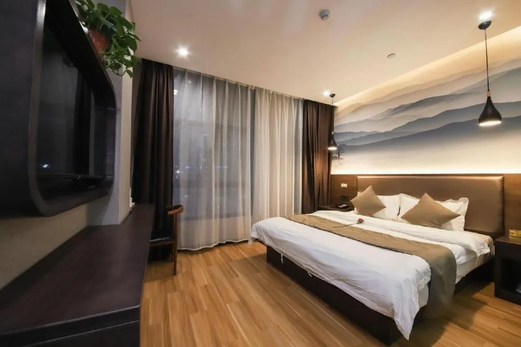 Bed in Shell Hotel Zhengzhou East High-Speed Railway Station Zhengdong Commerical Center