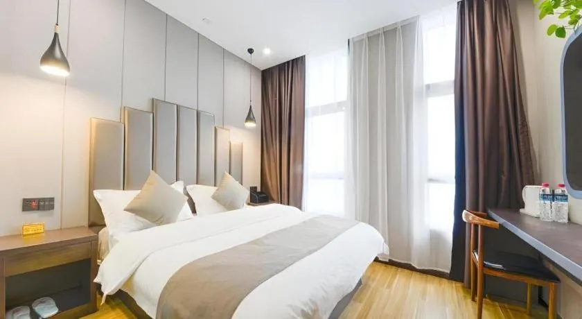 Bed in Shell Hotel Zhengzhou East High-Speed Railway Station Zhengdong Commerical Center