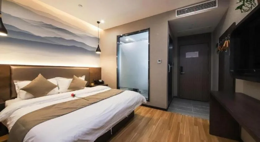 Bed in Shell Hotel Zhengzhou East High-Speed Railway Station Zhengdong Commerical Center