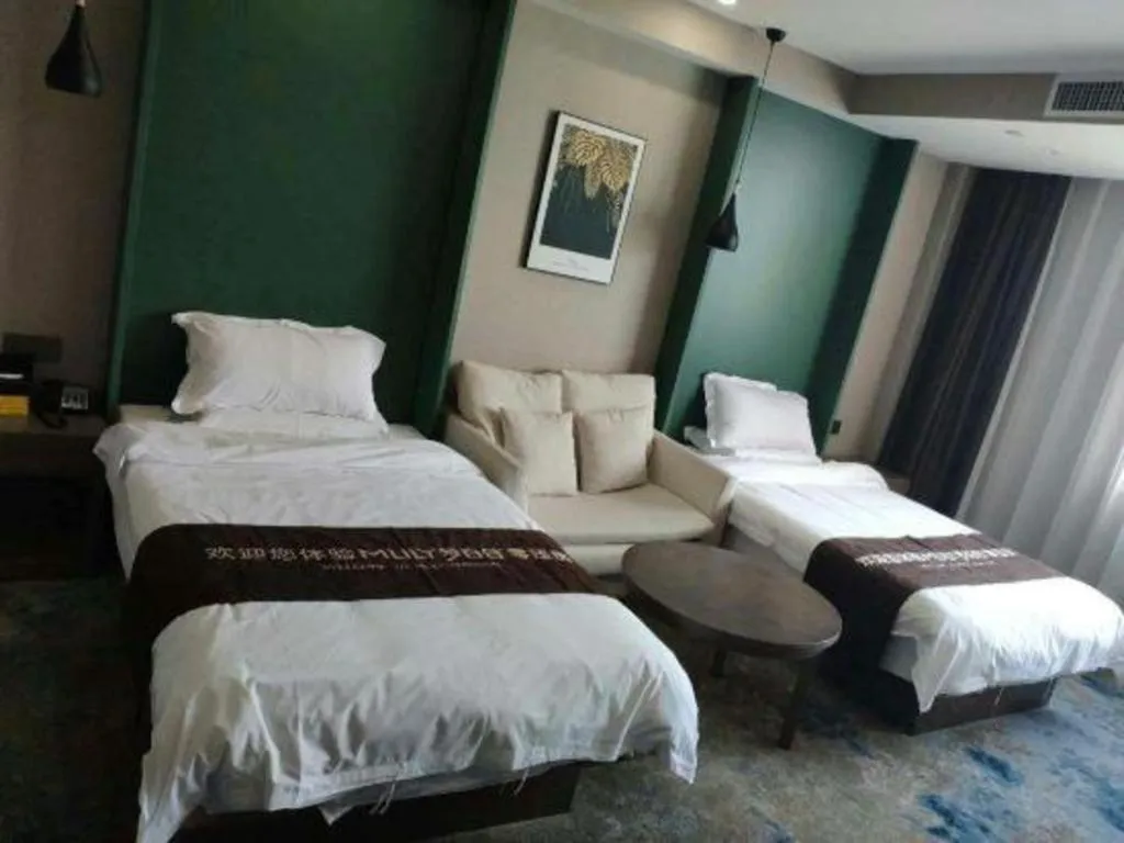 Bed in Shell Hotel Zhengzhou East High-Speed Railway Station Zhengdong Commerical Center
