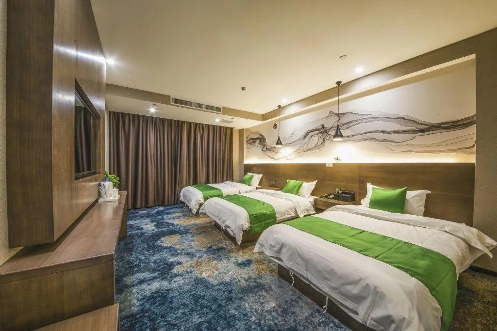 Bed in Shell Hotel Zhengzhou East High-Speed Railway Station Zhengdong Commerical Center