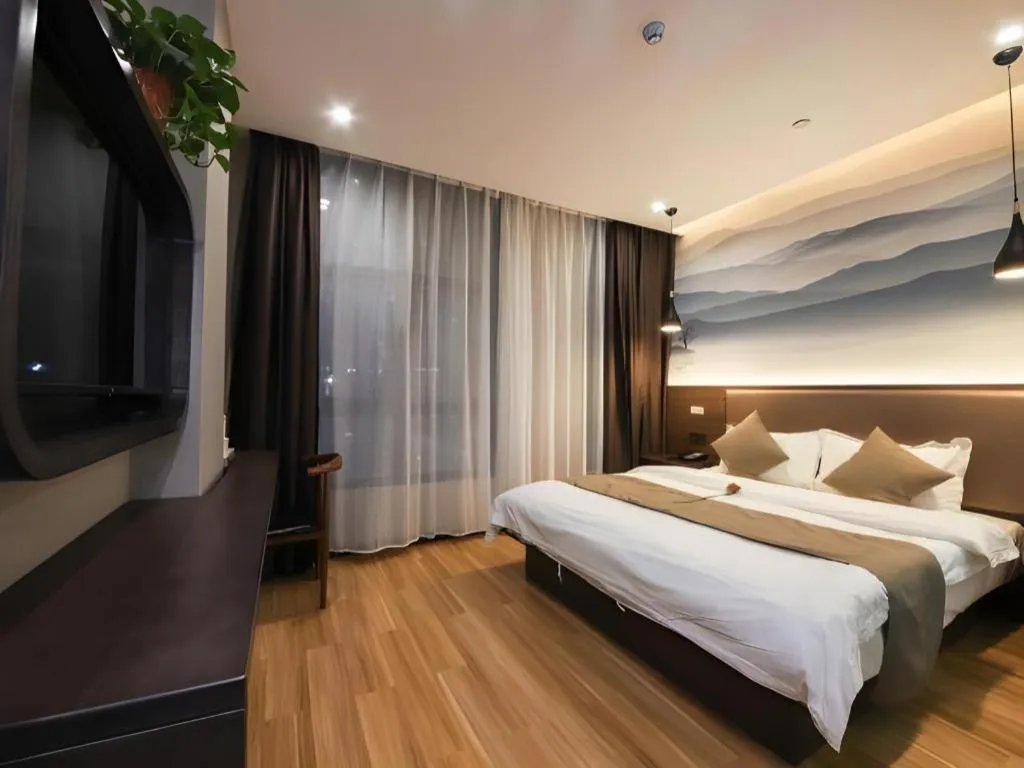 Bed in Shell Hotel Zhengzhou East High-Speed Railway Station Zhengdong Commerical Center