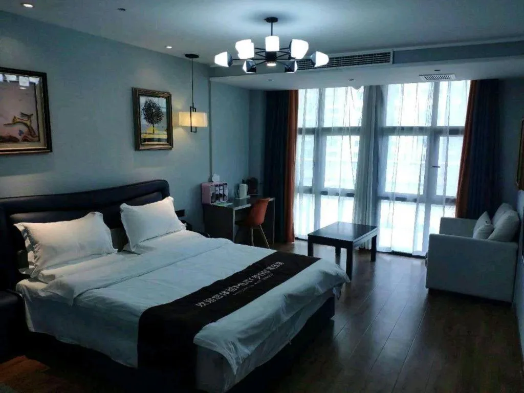 Bed in Shell Hotel Zhengzhou East High-Speed Railway Station Zhengdong Commerical Center
