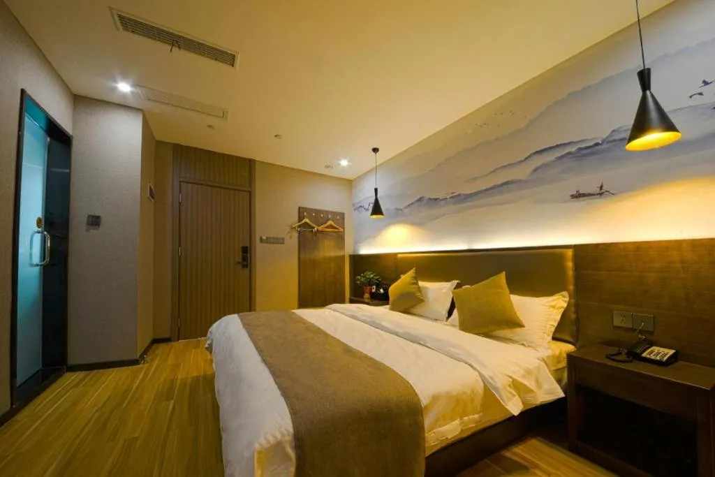 Bed in Shell Hotel Zhengzhou East High-Speed Railway Station Zhengdong Commerical Center