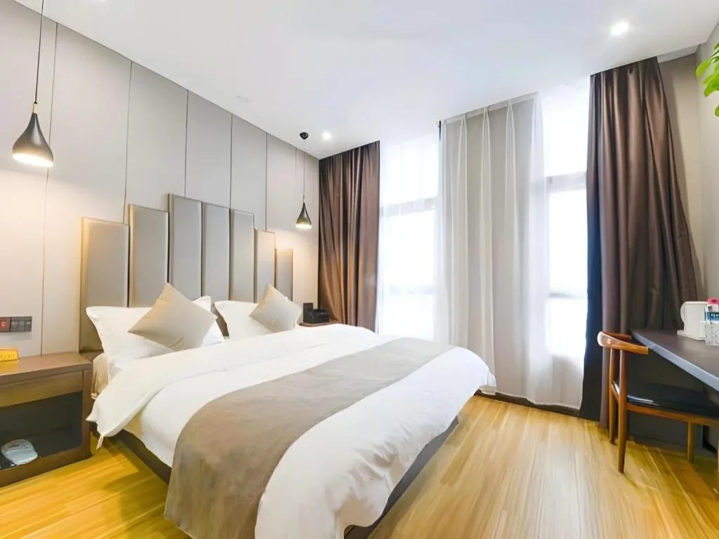 Bed in Shell Hotel Zhengzhou East High-Speed Railway Station Zhengdong Commerical Center