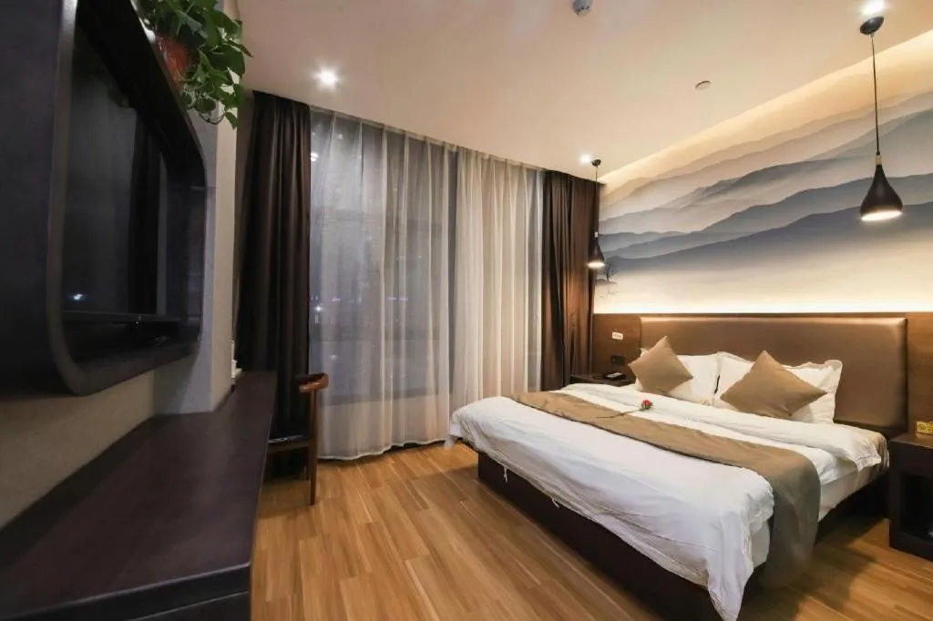 Bed in Shell Hotel Zhengzhou East High-Speed Railway Station Zhengdong Commerical Center