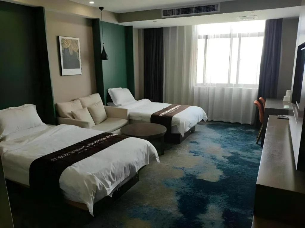 Bed in Shell Hotel Zhengzhou East High-Speed Railway Station Zhengdong Commerical Center