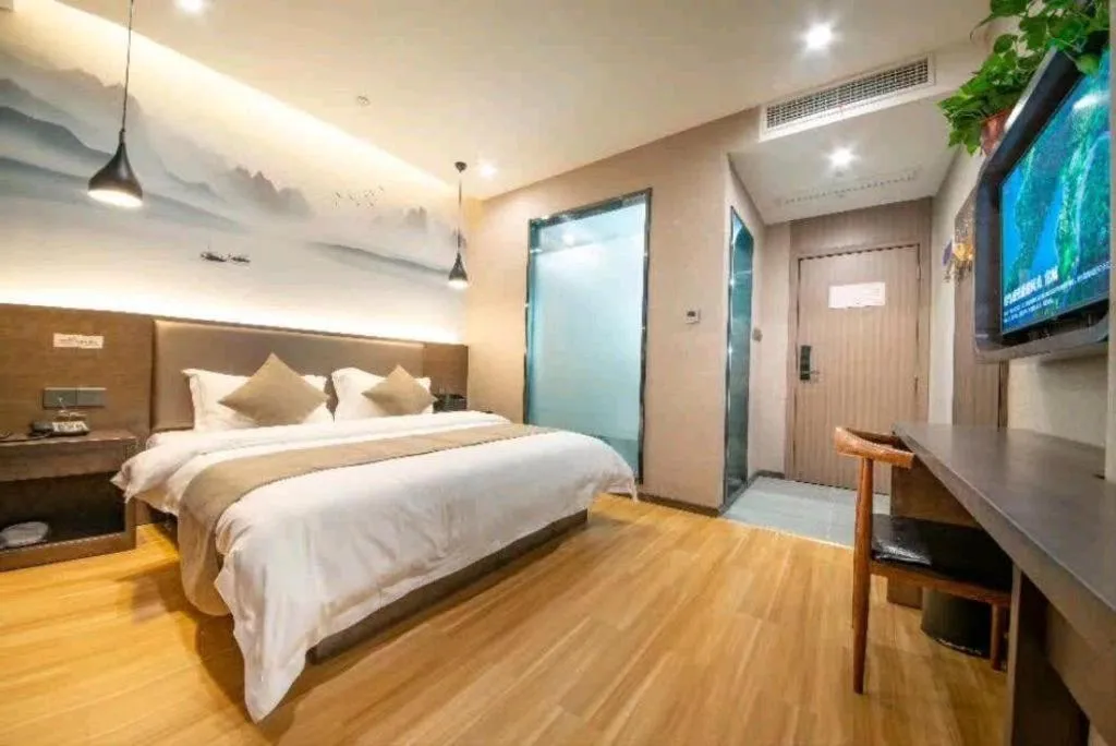 Bed in Shell Hotel Zhengzhou East High-Speed Railway Station Zhengdong Commerical Center