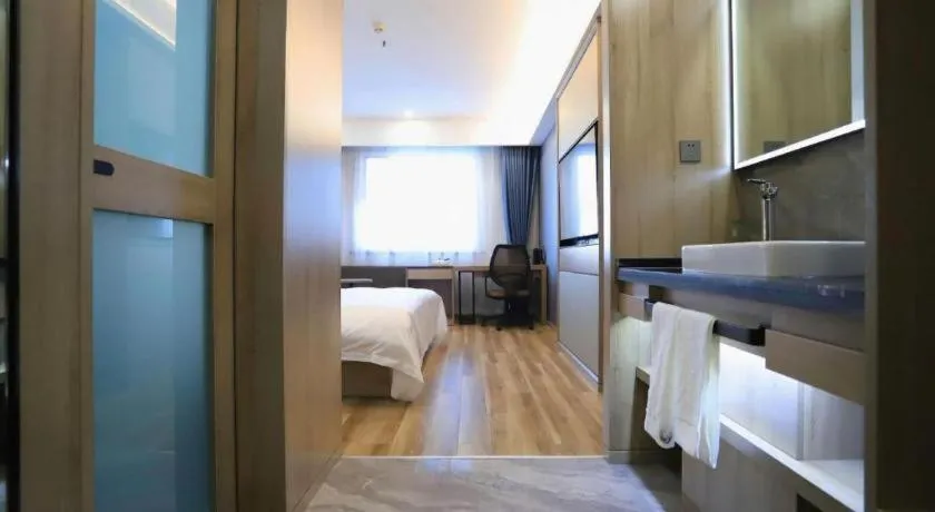 Bed in VX Hotel Jiangsu Taizhou Xinghua RT-Mart