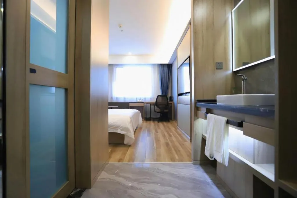 Bed in VX Hotel Jiangsu Taizhou Xinghua RT-Mart