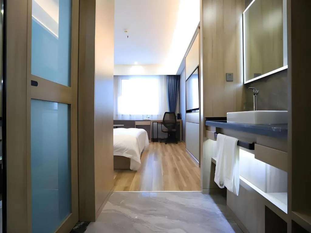 Bed in VX Hotel Jiangsu Taizhou Xinghua RT-Mart