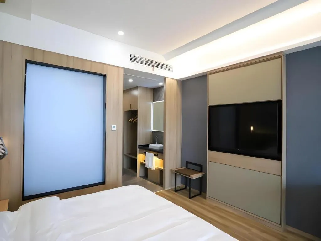 Bed in VX Hotel Jiangsu Taizhou Xinghua RT-Mart