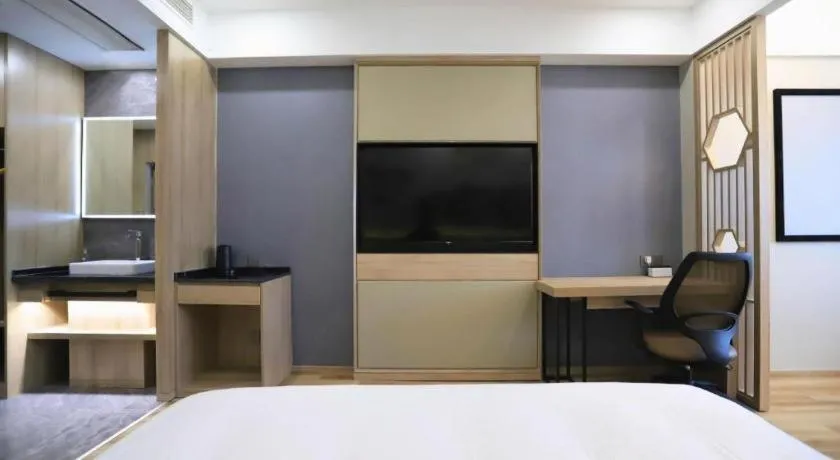 Bed in VX Hotel Jiangsu Taizhou Xinghua RT-Mart