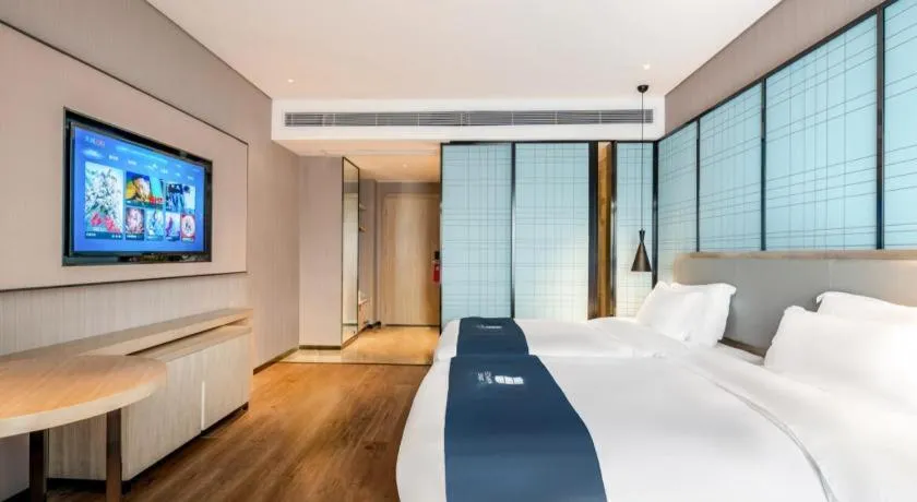 Bed in Echarm Hotel Suzhou Shengze Oriental Extile City