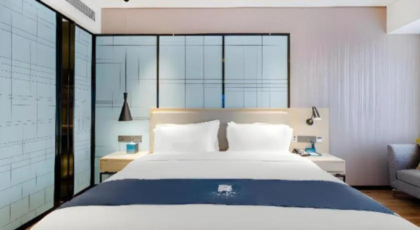 Bed in Echarm Hotel Suzhou Shengze Oriental Extile City