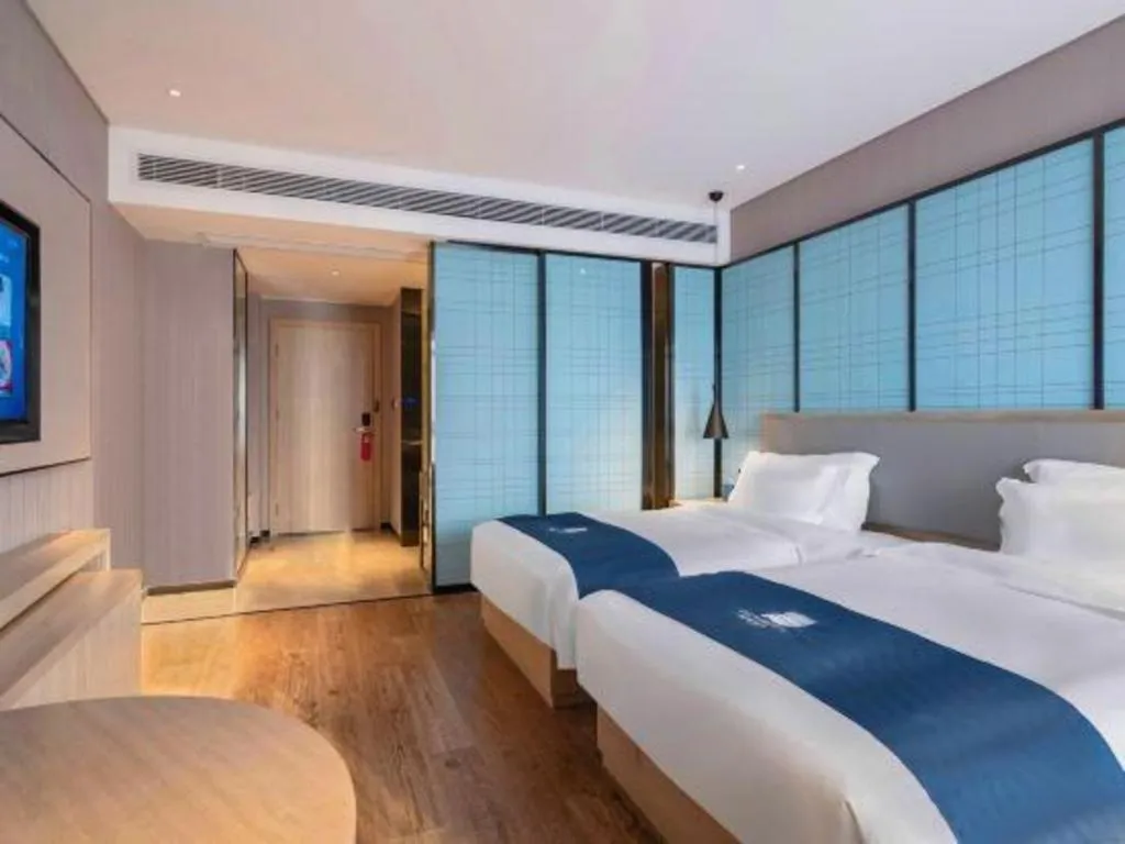 Bed in Echarm Hotel Suzhou Shengze Oriental Extile City