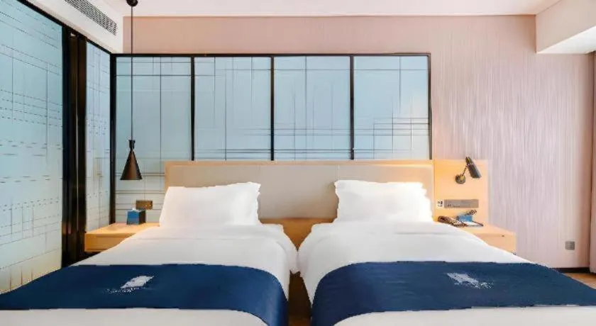 Bed in Echarm Hotel Suzhou Shengze Oriental Extile City