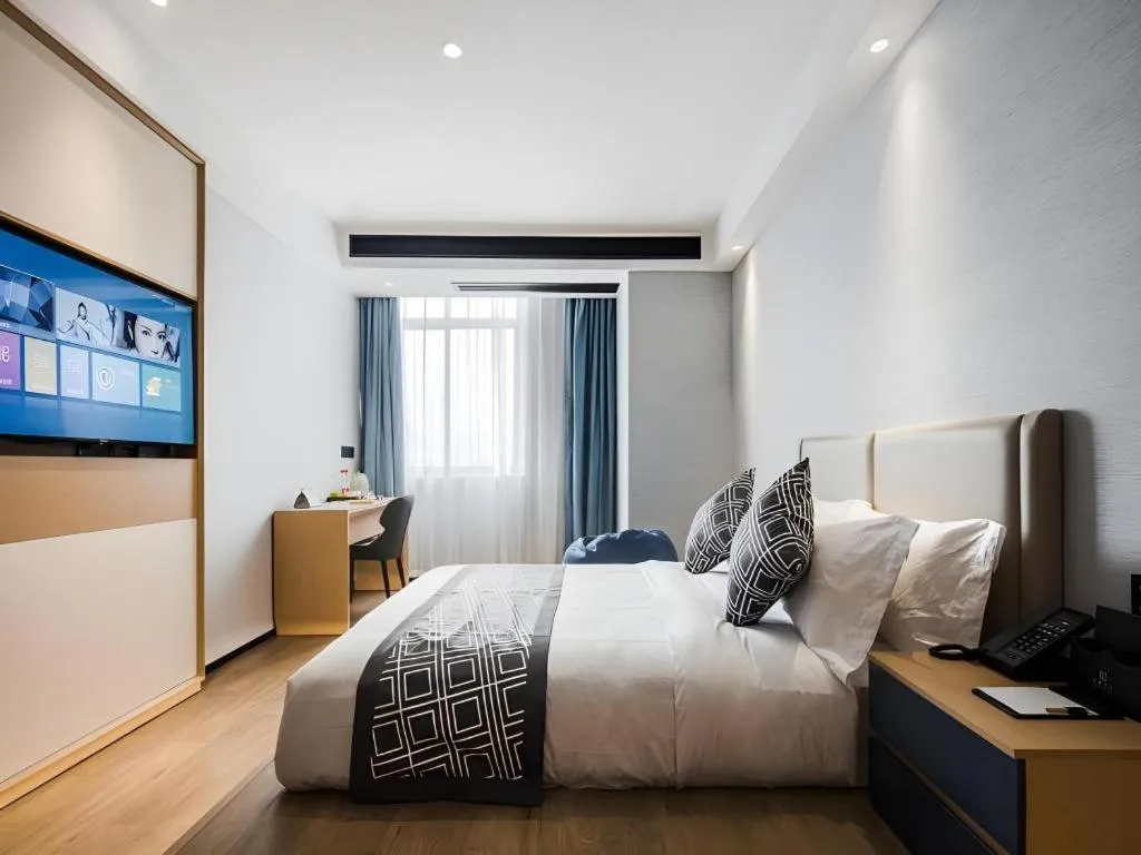 Bed in GEM Hotel Changzhou Xuejia'aoyuan North High-Speed Railway Station