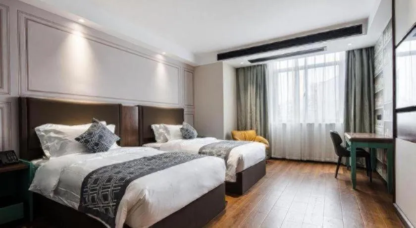 Bed in GEM Hotel Changzhou Xuejia'aoyuan North High-Speed Railway Station