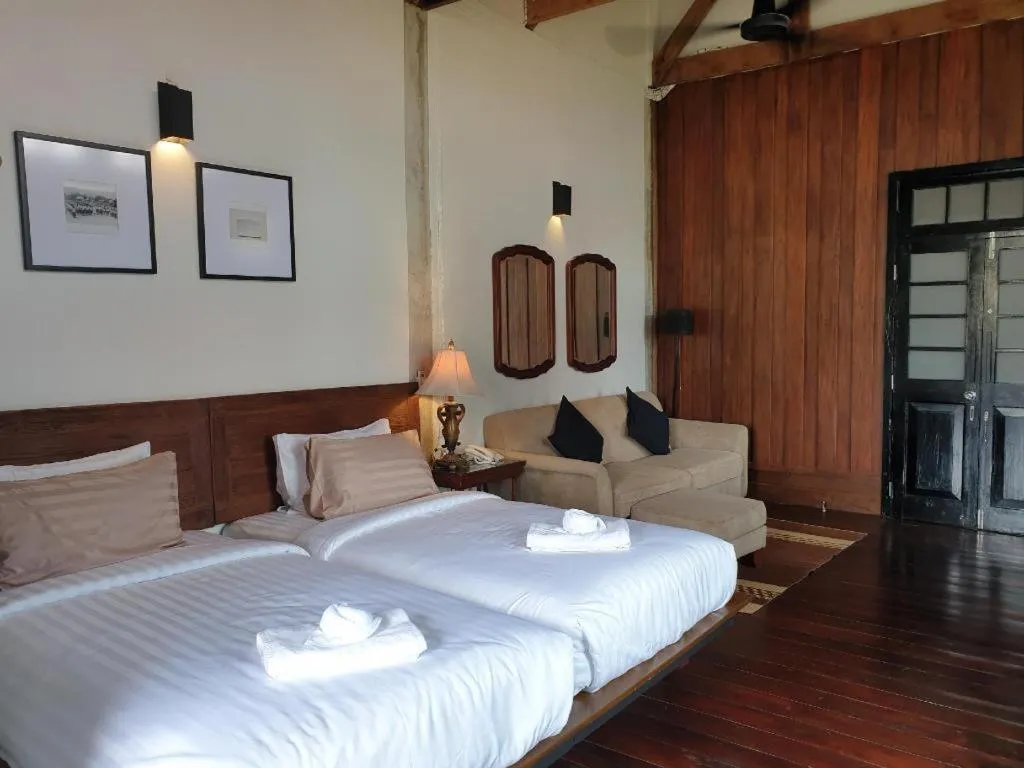 Bed in Uthai Heritage Hotel