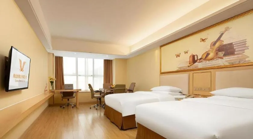 Bed in Vienna Hotel Chongqing Shizhu Stadium