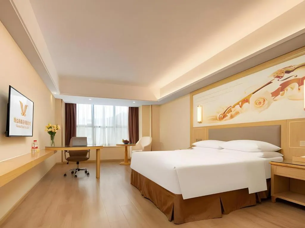 Bed in Vienna Hotel Chongqing Shizhu Stadium