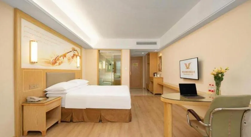 Bed in Vienna Hotel Chongqing Shizhu Stadium