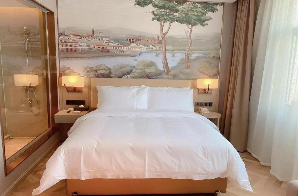 Bed in Vienna Hotel Lincang New Asia Pacific Times Square