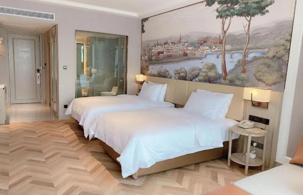 Bed in Vienna Hotel Lincang New Asia Pacific Times Square