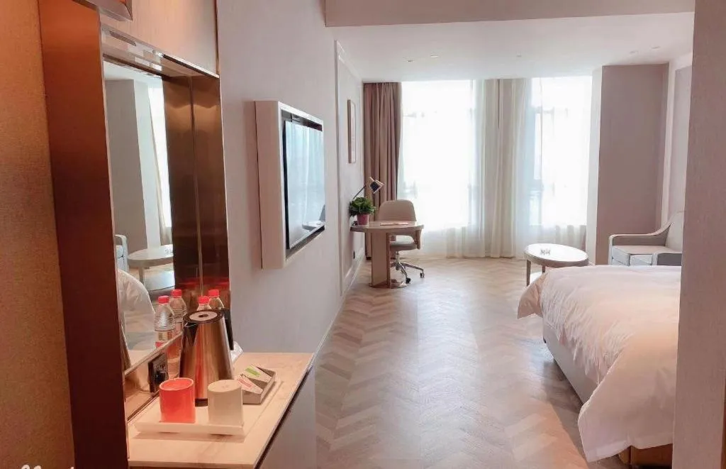 Bed in Vienna Hotel Lincang New Asia Pacific Times Square