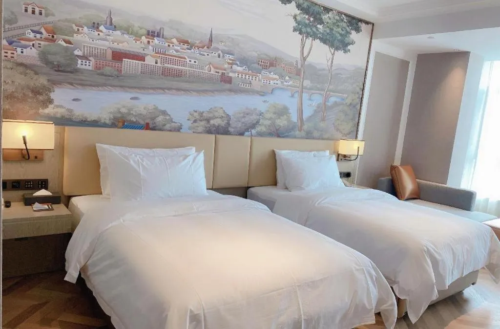 Bed in Vienna Hotel Lincang New Asia Pacific Times Square