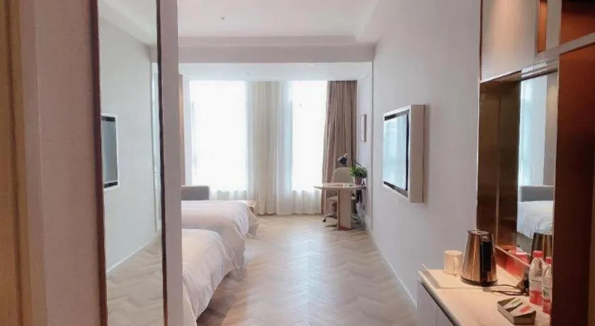 Bed in Vienna Hotel Lincang New Asia Pacific Times Square