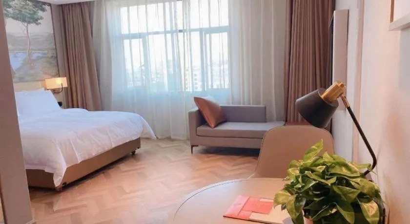 Bed in Vienna Hotel Lincang New Asia Pacific Times Square