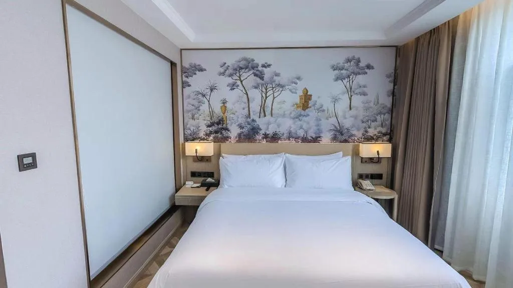 Bed in Vienna Hotel Lincang New Asia Pacific Times Square