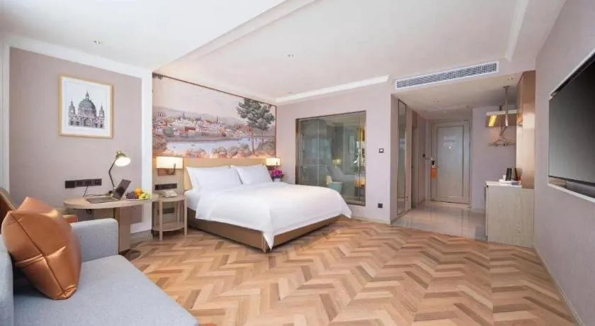 Bed in Vienna Hotel Lincang New Asia Pacific Times Square