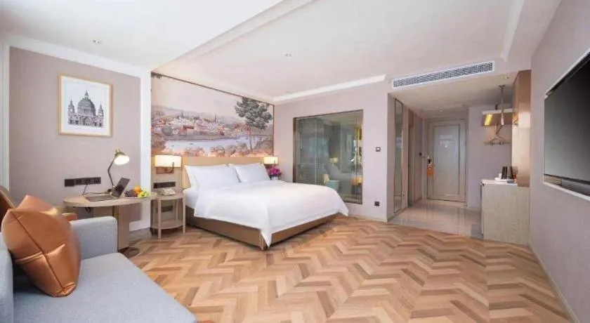 Bed in Vienna Hotel Lincang New Asia Pacific Times Square