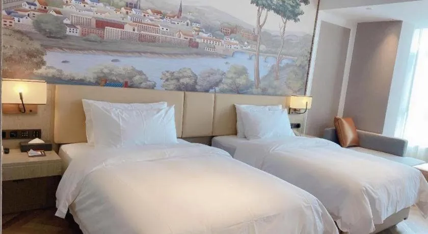 Bed in Vienna Hotel Lincang New Asia Pacific Times Square