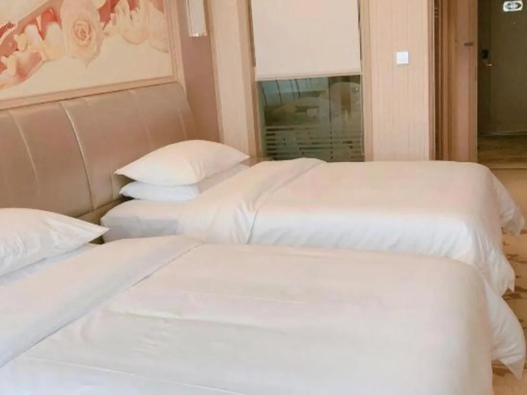 Bed in Vienna Hotel Guangxi Zhongshan Central Plaza West High-Speed Railway Station