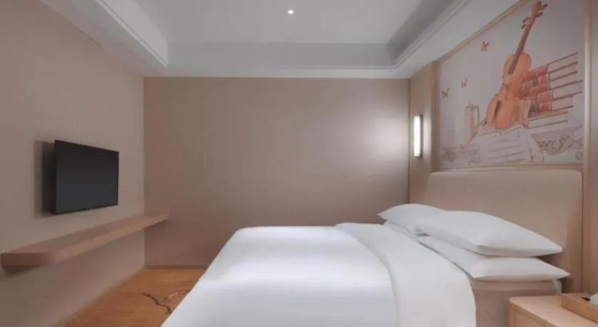 Bed in Vienna Hotel Zhejiang Tongxiang Puyuan