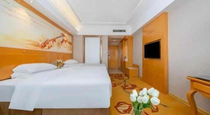Bed in Vienna Hotel Guangxi Fangcheng
