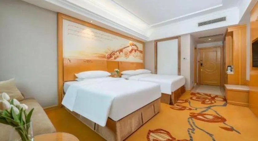 Bed in Vienna Hotel Guangxi Fangcheng