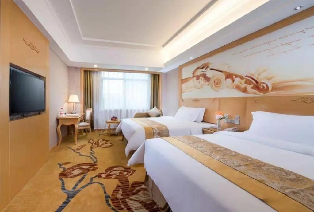 Bed in Vienna Hotel Guangxi Fangcheng