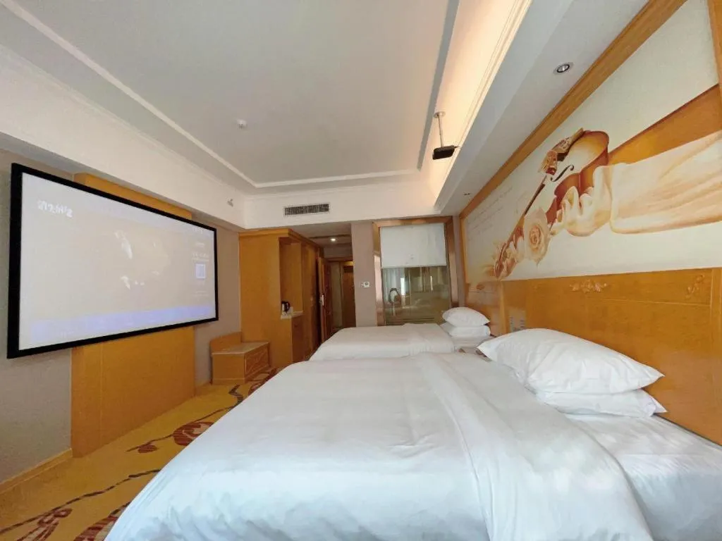 Bed in Vienna Hotel Guangxi Fangcheng