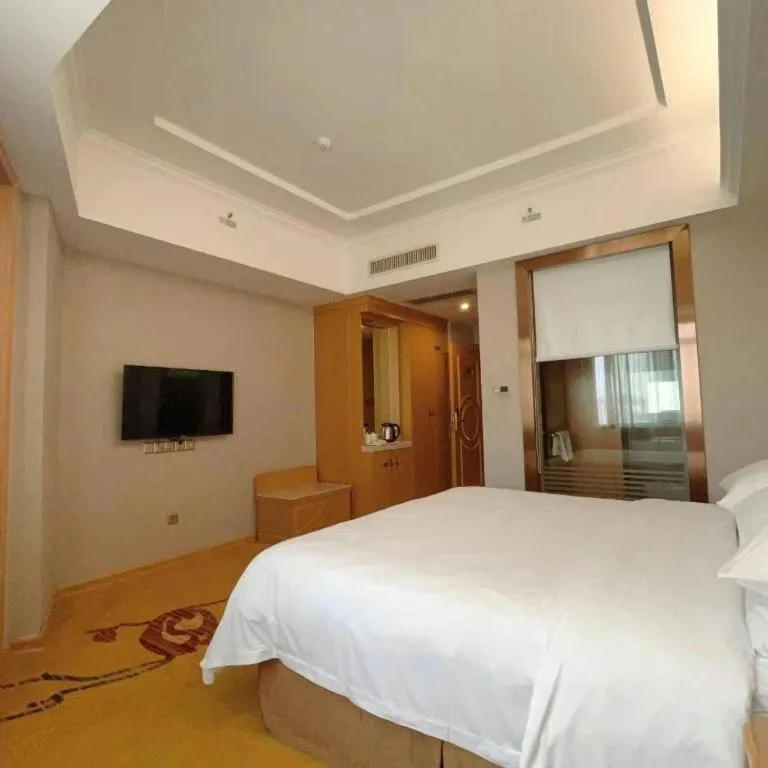 Bed in Vienna Hotel Guangxi Fangcheng