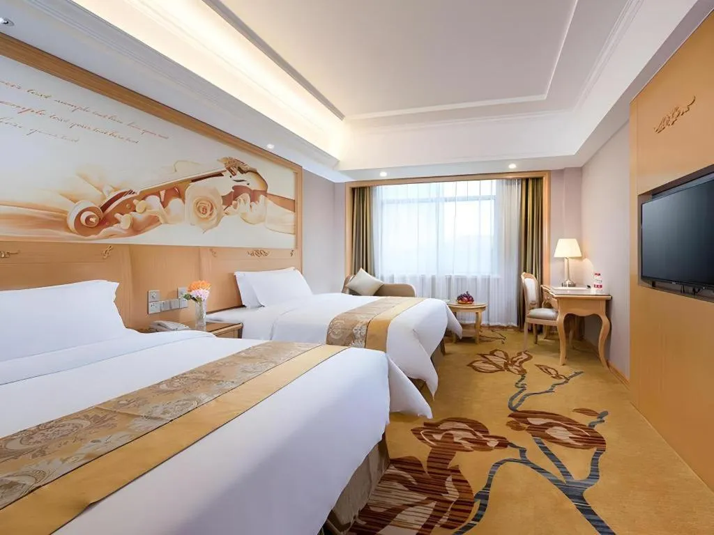 Bed in Vienna Hotel Guangxi Fangcheng