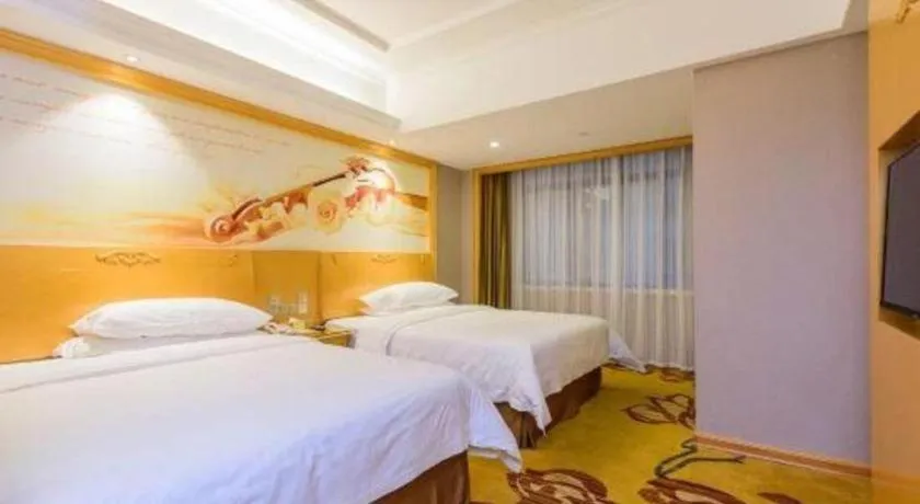 Bed in Vienna Hotel Guangxi Fangcheng