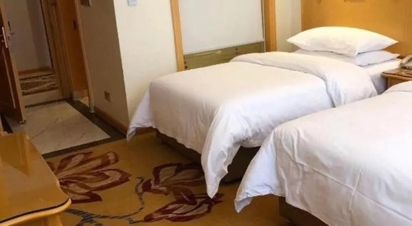Bed in Vienna Hotel Guangdong Zhaoqing Sihui Tianguangxu